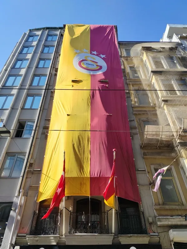 A giant yellow-and-red Galatasaray banner hanging down a building facade